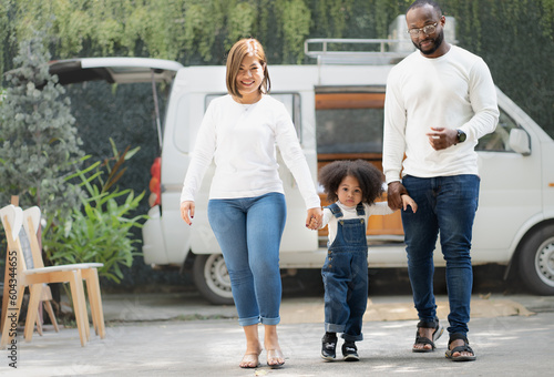 Fotografia Smiling biracial child and family have fun together outdoors