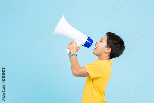 Cuadro en lienzo Cute boy shouting on megaphone isolated on light blue background