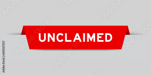 Red color inserted label with word unclaimed on gray background