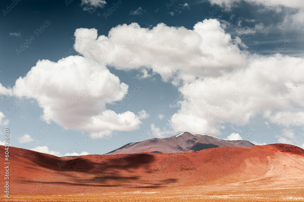 Desert landscape with red hills and the blue sky with clouds, Altiplano plateau, Bolivia.
