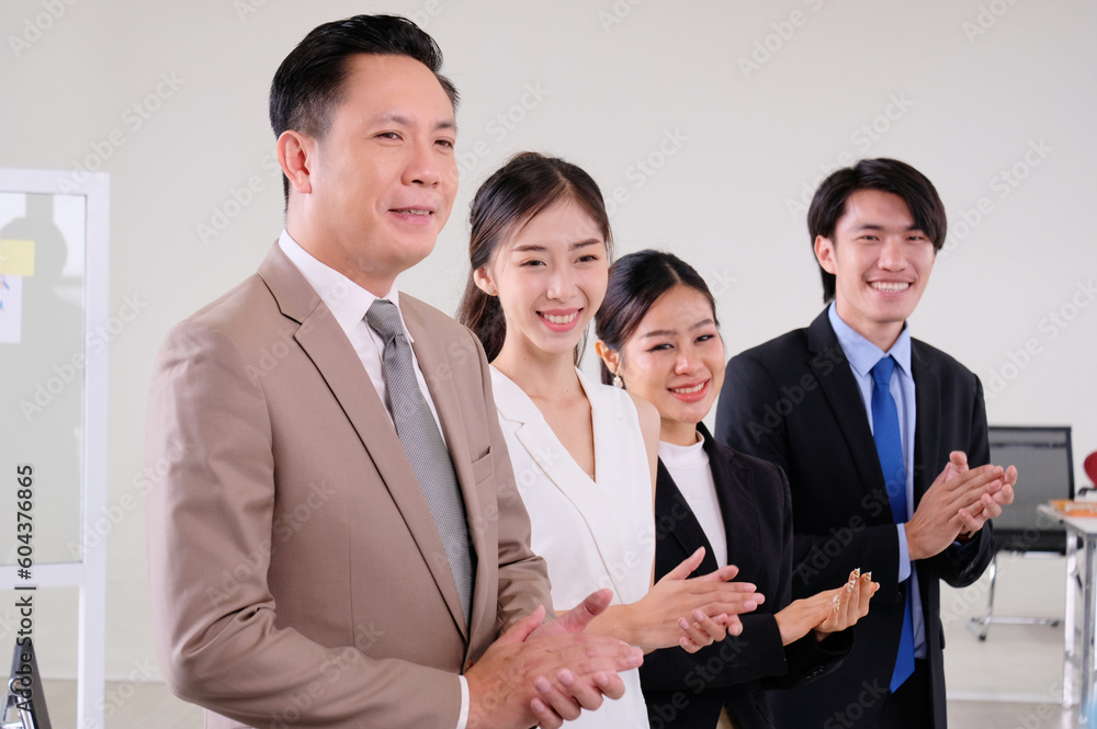 Business team smiling and clapping congratulations on business. Business team smiling and clapping congratulations on business.