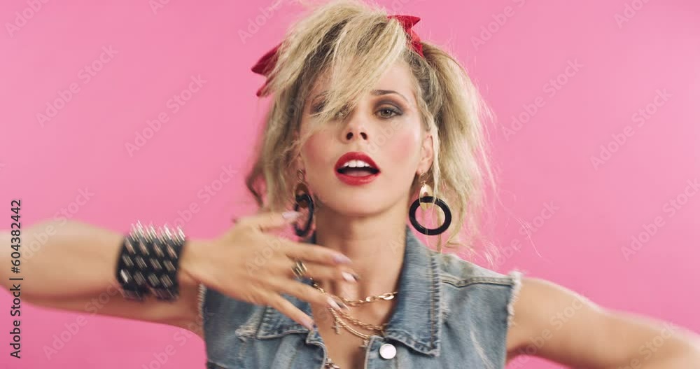 Dance, 80s fashion and face of a woman isolated on a pink background in a studio. Makeup, retro and portrait of a dancing vintage girl with punk clothes, style and looking old school on a backdrop