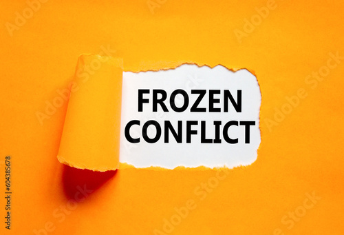 Frozen conflict symbol. Concept words Frozen conflict on beautiful white paper. Beautiful orange table orange background. Business and Frozen conflict concept. Copy space.