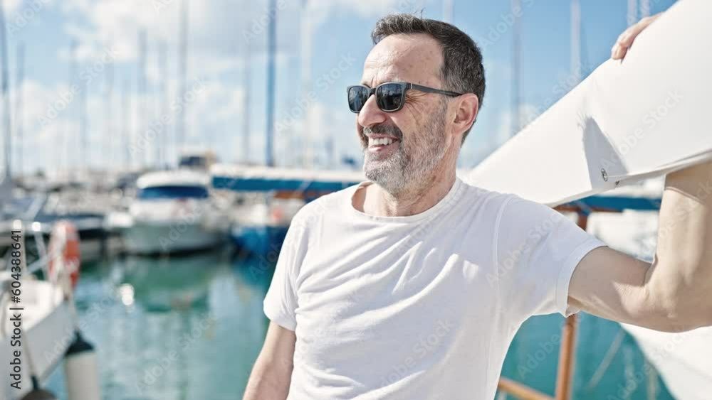 Middle age man smiling confident wearing sunglasses at boat Middle age man smiling confident wearing sunglasses at boat
