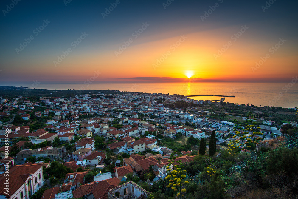 Fototapeta premium Beautiful sunset view by the historical castle of Kyparissia coastal town at sunset. Located in northwestern Messenia, Peloponnese, Greece, Europe.