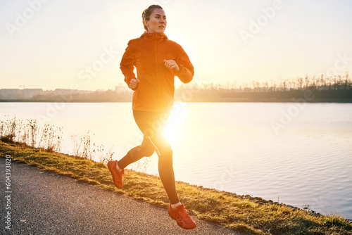 Fototapeta Naklejka Na Ścianę i Meble -  Woman running outdoors. Healthy lifestyle concept, people go in sports. Silhouette family at sunset. Health care, authenticity, sense of balance and calmness.
