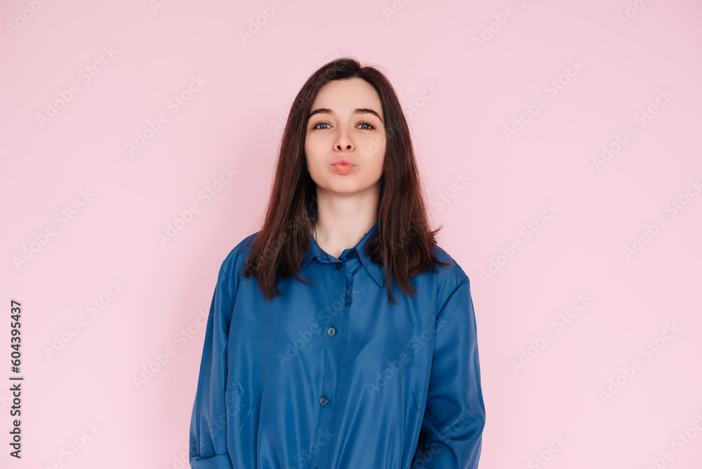 Radiant Elegance: Stunning Portrait of a Gorgeous Lady with Pouted Lips and a Playful Kiss, Wearing a Stylish Smart Casual Shirt, Isolated on a Captivating Pink Background Radiant Elegance: Stunning Portrait of a Gorgeous Lady with Pouted Lips and a Playful Kiss, Wearing a Stylish Smart Casual Shirt, Isolated on a Captivating Pink Background
