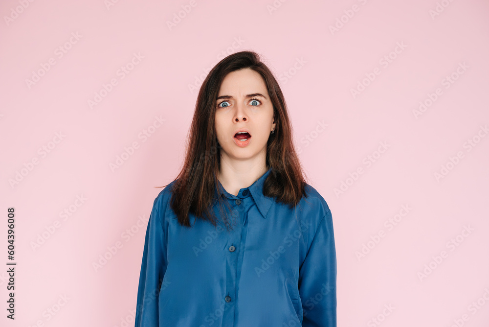 Stunning Portrait of a Speechless Woman in Utter Shock, Wide Open Mouth, Expressing Unbelievable Surprise - Isolated on Vibrant Pink Background Stunning Portrait of a Speechless Woman in Utter Shock, Wide Open Mouth, Expressing Unbelievable Surprise - Isolated on Vibrant Pink Background