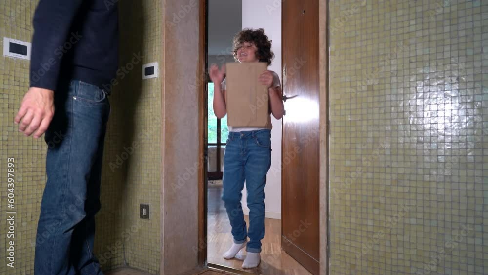 Boy child 8 years open door at delivery man that arrives home in the apartment house - home delivery on the landing outside the door during childhood - present for Christmas and birthday Boy child 8 years open door at delivery man that arrives home in the apartment house - home delivery on the landing outside the door during childhood - present for Christmas and birthday