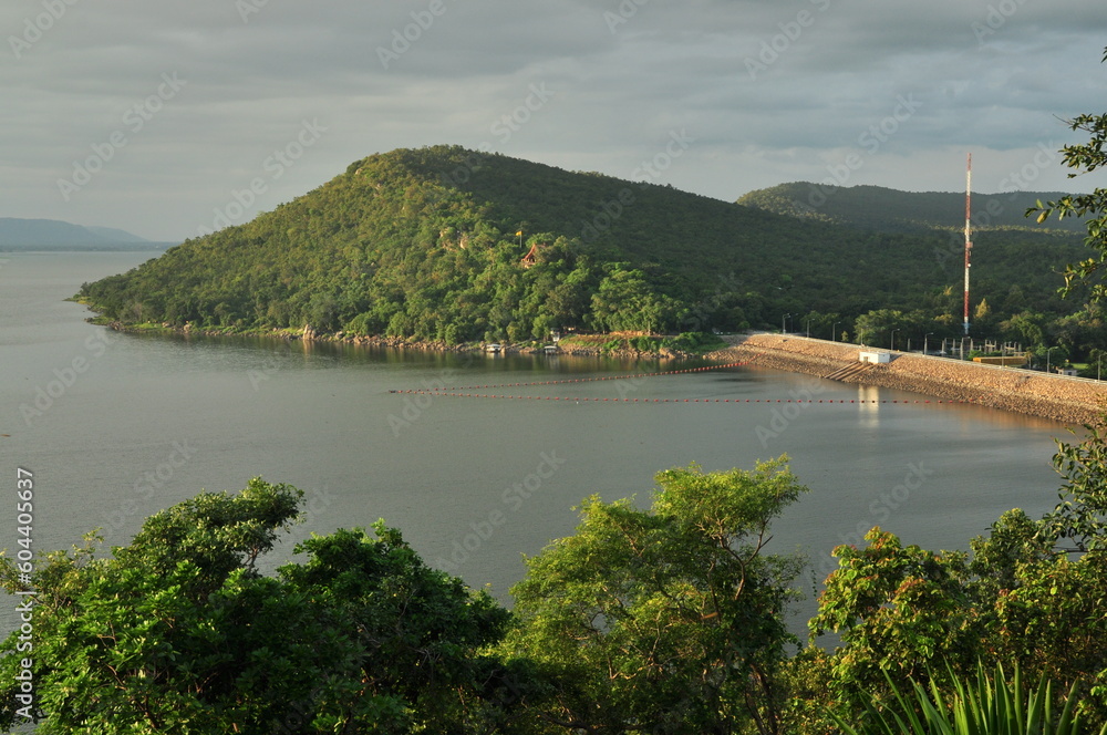 Overview of Ubonrat Dam, famous Dam in northeast of Thailand, mountain and green scene, tree at foreground