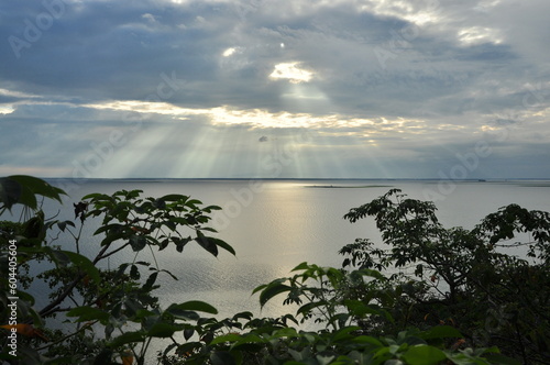 Beautiful sunset light with cloudy sky and tree in foreground at Ubol Ratana Dam, northeast of Thailand photo