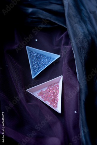 Triangular capacitances filled with beads on a dark background photo