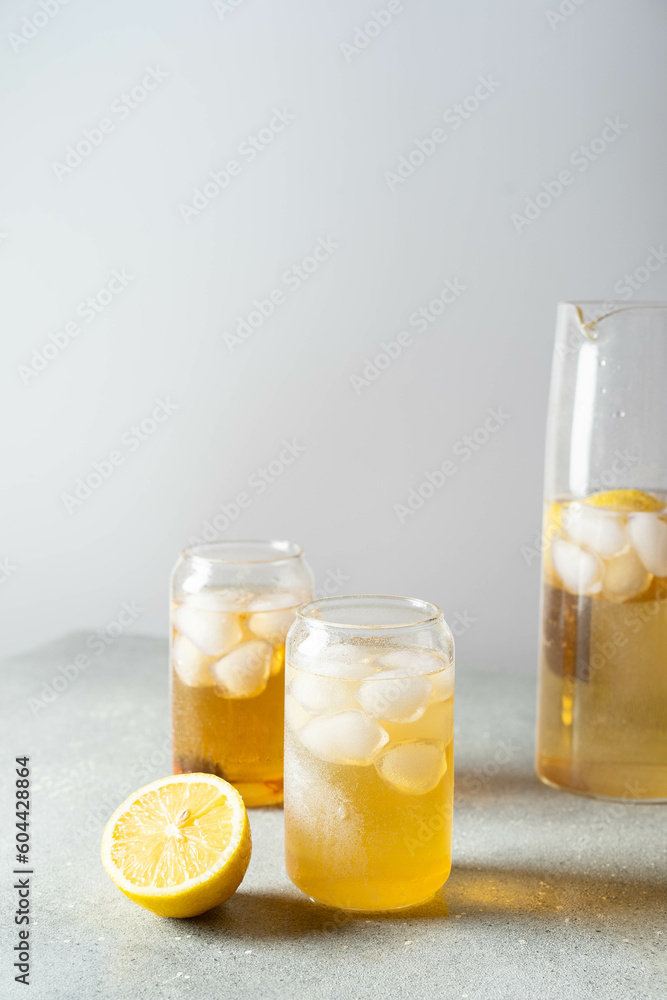 Black tea with ice and lemon in a tall glass. Cold lemonade. Black tea with ice and lemon in a tall glass. Cold lemonade.