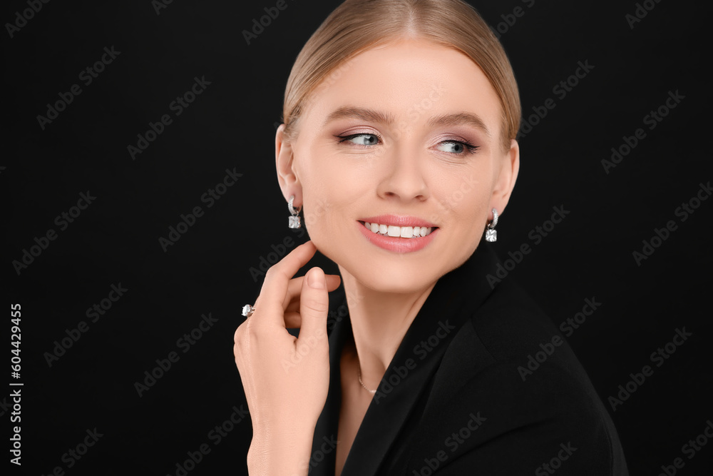 Beautiful young woman with elegant jewelry on black background Beautiful young woman with elegant jewelry on black background
