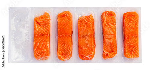 Photography Pieces of frozen fish salmon in plastic packaging isolated on white background