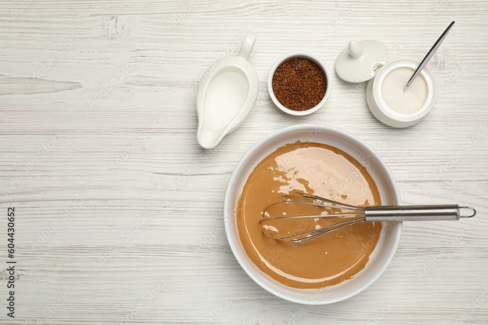 Whipping cream for dalgona coffee and ingredients on white wooden table, flat lay. Space for text Whipping cream for dalgona coffee and ingredients on white wooden table, flat lay. Space for text
