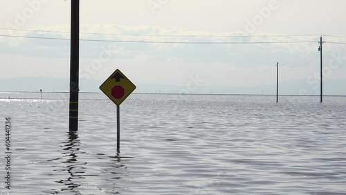 2023 - Road signs and powerlines stick out of a flooded area near Tulare Lake in Corcoran, California. photo