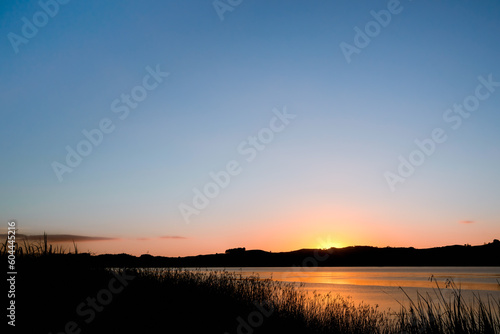 Sunrise over calm river