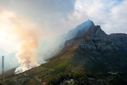 Controlled burn on a March morning 2023 at the foot of Table Mountain in Cape Town, South Africa. View a sunrise hike to Lions Head.