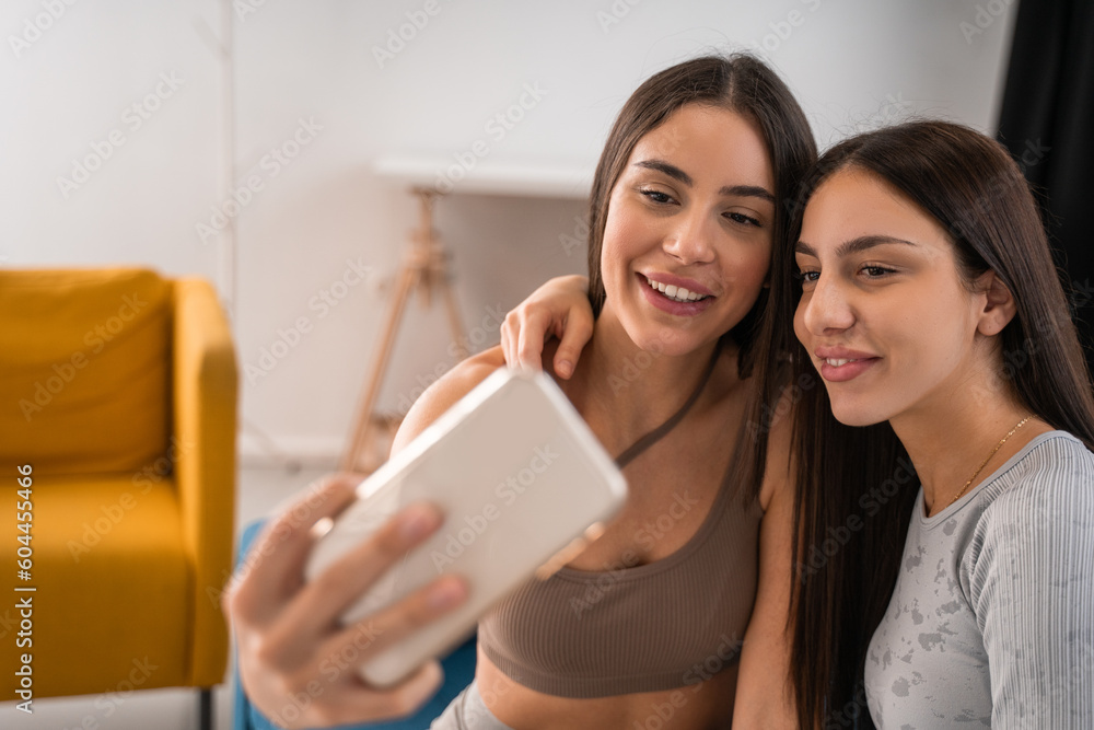 Glad young woman taking selfie on modern smartphone Glad young woman taking selfie on modern smartphone