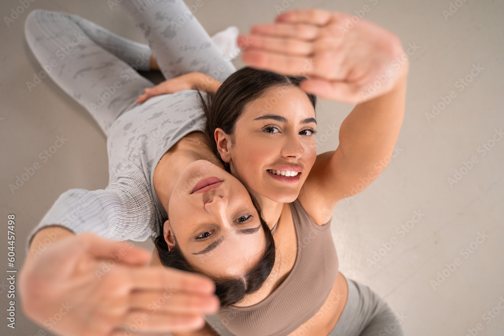 Gorgeous brunettes bonding heads while posing to camera together Gorgeous brunettes bonding heads while posing to camera together