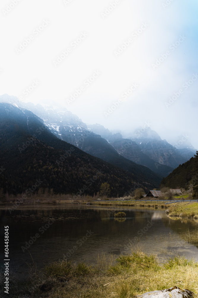 La Pineta reservoir with mountains in the background and storm clouds (Bielsa, Pyrenees, Spain)