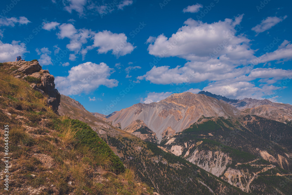 A male hiker resting during a hike to Col du Cros in the French Alps