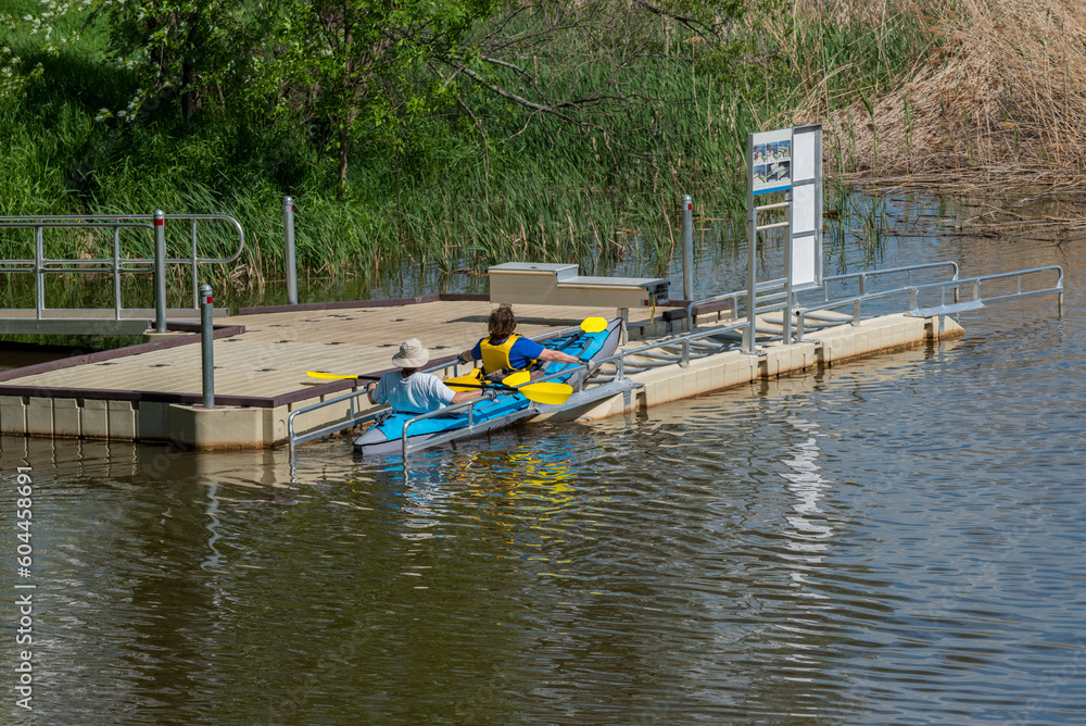 People At the Kayak Launch Dock On The River In Spring