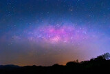 Majestic Celestial Symphony: In this captivating photograph, the milky way unfurls across the night sky like a symphony of stars. The celestial band of twinkling lights stretches across the horizon, 
