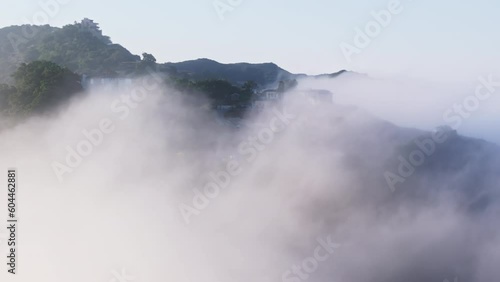 Wallpaper Mural Drone flying around mansion house on mountain peak covered by clouds at sunrise. Cinematic cloudscape floating around green forest on mountain summit with blue sky on background Aerial view 4K Torontodigital.ca