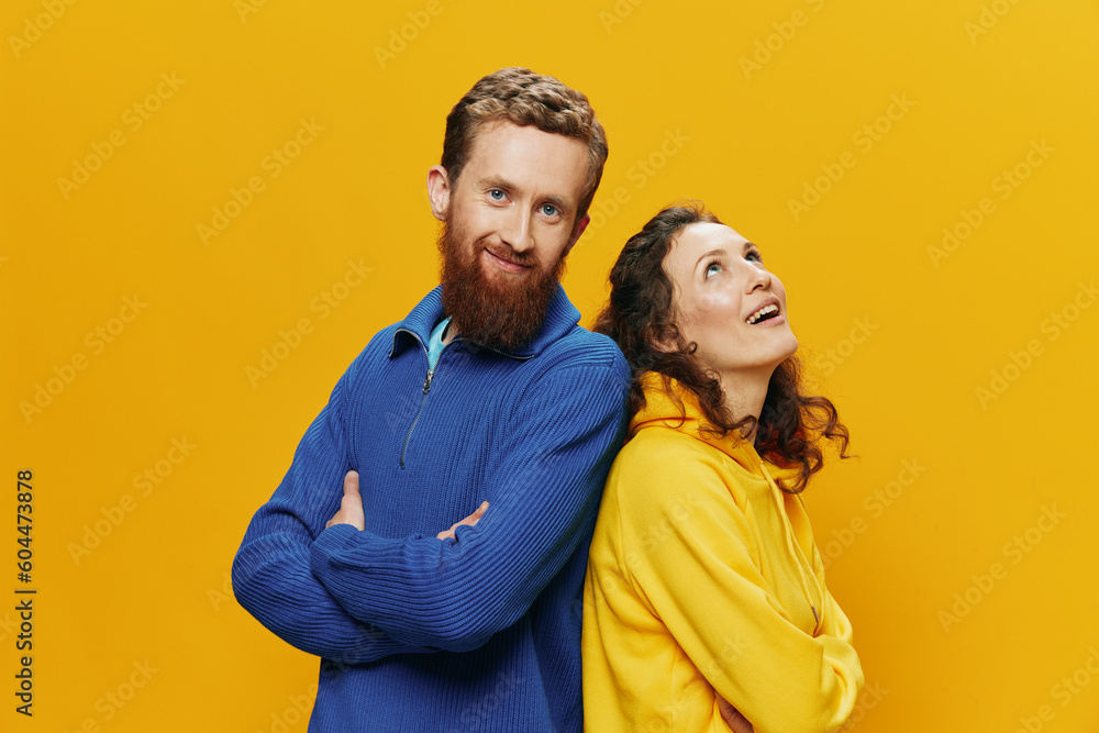 Obraz premium Man and woman couple smiling cheerfully and crooked with glasses, on yellow background, symbols signs and hand gestures, family shoot, newlyweds.