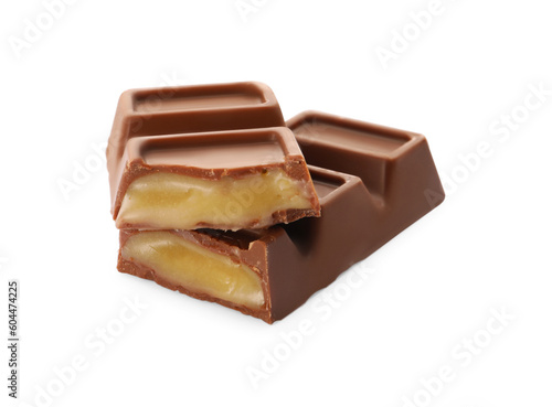 Pieces of delicious chocolate bar on white background