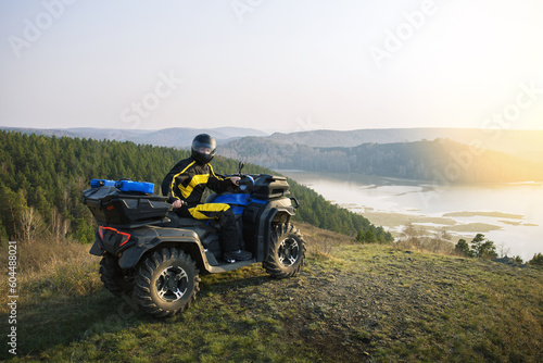 Man driving off road adventure with ATV car, quad bike on the mountain.