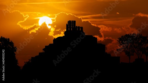 Maya Pyramid of Edzna complex, the Temple five floors Time Lapse at Sunset with Red Sky and Fiery Sun, Mexico photo