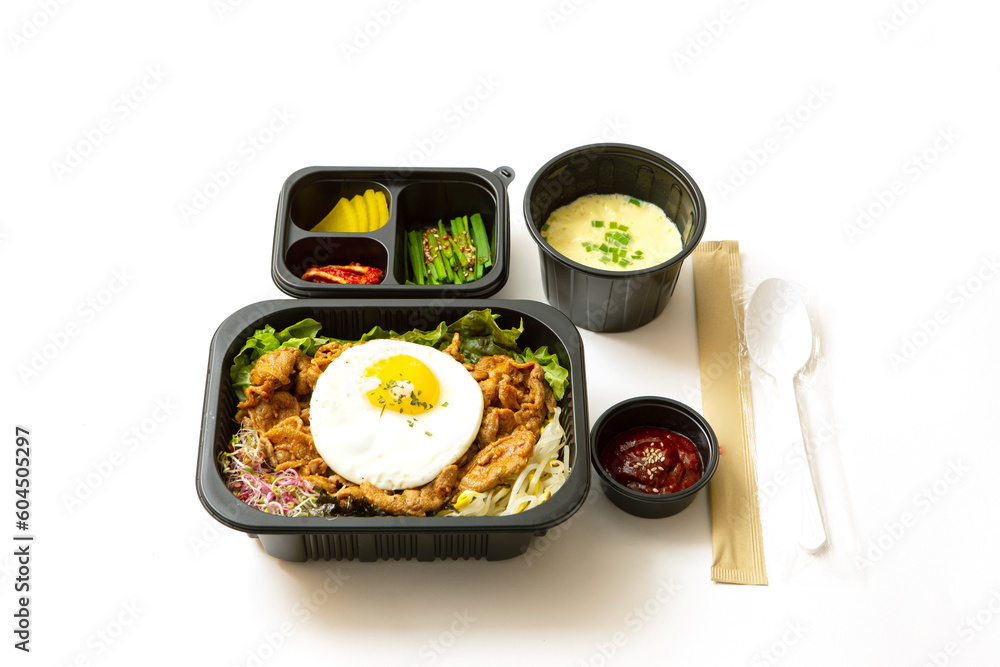 Spicy stir-fried meat and side dishes in a take-out container Spicy stir-fried meat and side dishes in a take-out container