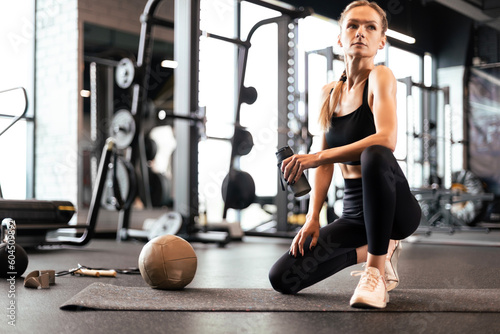 Sporty woman resting  having break after doing exercise.