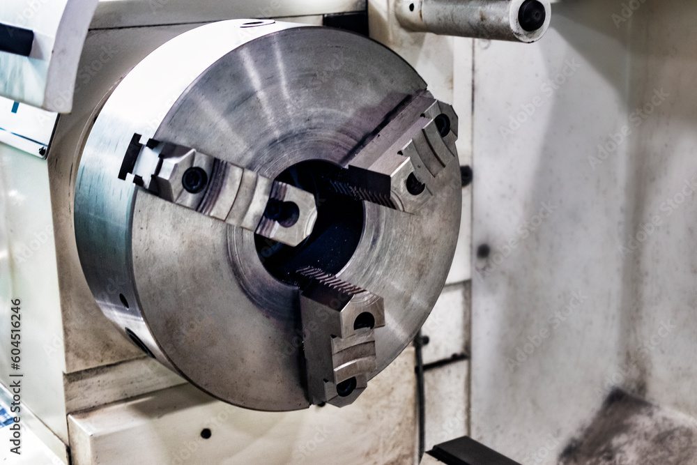 An element of a lathe for fixing a metal part for processing. Industrial processing of metal products with a cutting tool on an automatic lathe.