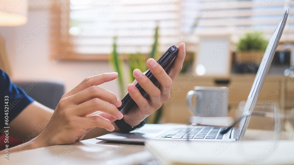 Fototapeta premium Happy young man checking social media or shopping online on smart phone..