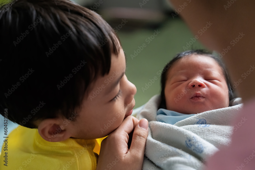 Older brother watching younger brother who was just born Older brother watching younger brother who was just born
