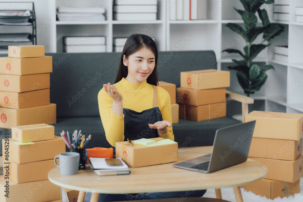 tarting Small business entrepreneur SME freelance,Portrait young woman working at home office, BOX,smartphone,laptop, online, marketing, packaging, delivery, SME, e-commerce concept tarting Small business entrepreneur SME freelance,Portrait young woman working at home office, BOX,smartphone,laptop, online, marketing, packaging, delivery, SME, e-commerce concept