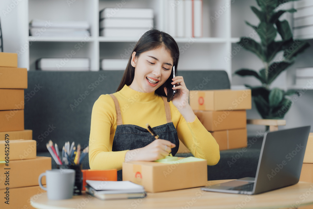 tarting Small business entrepreneur SME freelance,Portrait young woman working at home office, BOX,smartphone,laptop, online, marketing, packaging, delivery, SME, e-commerce concept tarting Small business entrepreneur SME freelance,Portrait young woman working at home office, BOX,smartphone,laptop, online, marketing, packaging, delivery, SME, e-commerce concept