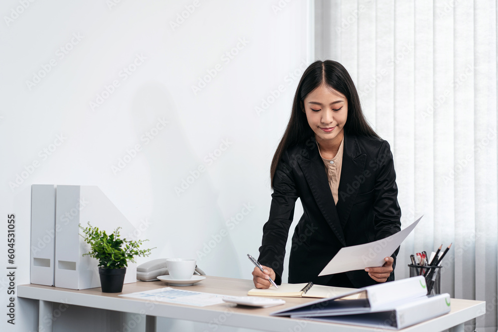 Business woman is holding business document to reading financial Business woman is holding business document to reading financial