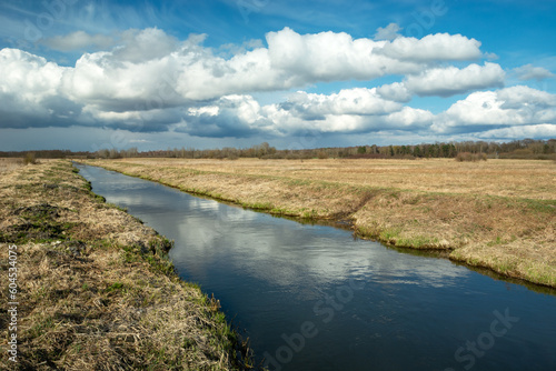 Cumulus clouds over the Uherka River in eastern Poland