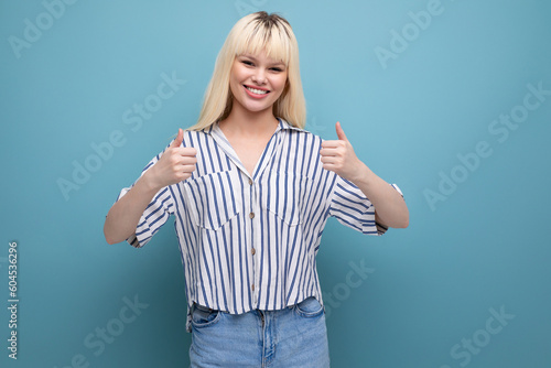 positive energetic pretty european 20s woman in striped shirt on studio background