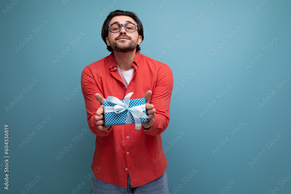 joyful cute young guy with chic black hair received a gift joyful cute young guy with chic black hair received a gift