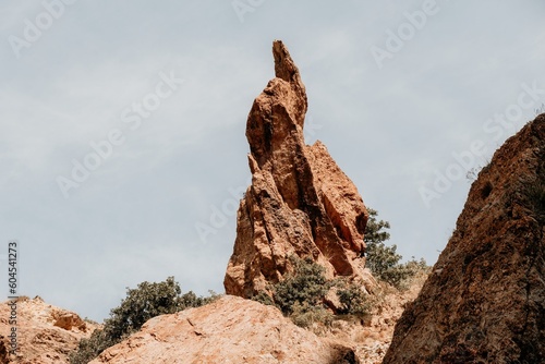 A close up of rocks that look like the beak of a bird or a sharp nose The picturesque volcanic coast of the island on the ocean waters - sharp rocks  dark stones