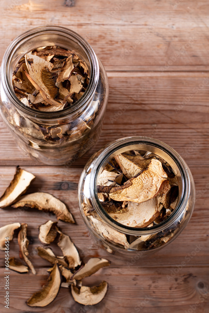 Dried mushrooms. Mushrooms in jar on the wooden table. Top view Dried mushrooms. Mushrooms in jar on the wooden table. Top view