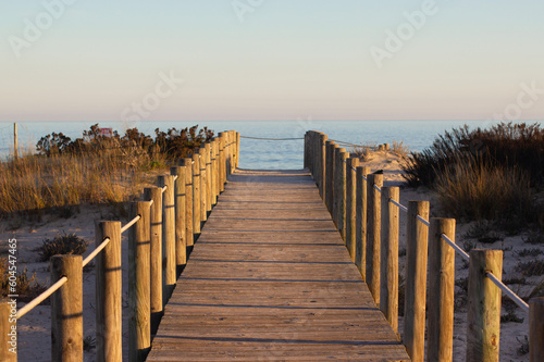 wooden path to the beach in summer to watch the sunset