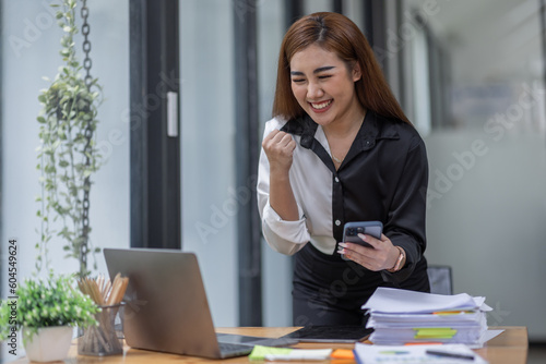 Young happy excited asian woman, professional entrepreneur work in office clothing, smiling and looking confident, workplace background
