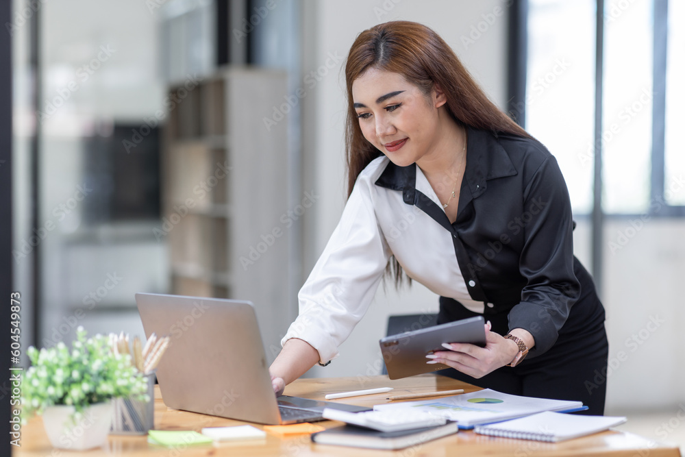 Business Asian woman working at office with documents on his desk, doing planning analyzing the financial report, business plan investment, finance analysis concept Business Asian woman working at office with documents on his desk, doing planning analyzing the financial report, business plan investment, finance analysis concept